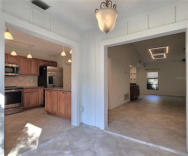 kitchen with decorative backsplash, stainless steel appliances, ceiling fan, pendant lighting, and light tile patterned flooring