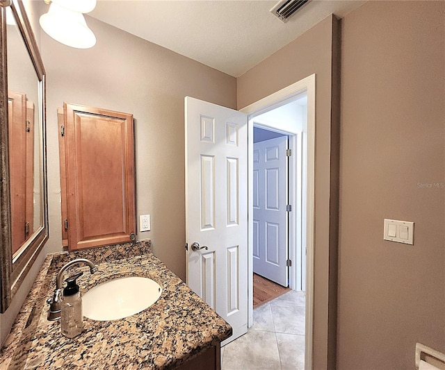 bathroom with tile patterned flooring and vanity