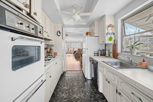 kitchen featuring white cabinetry, sink, ceiling fan, dark hardwood / wood-style flooring, and white appliances