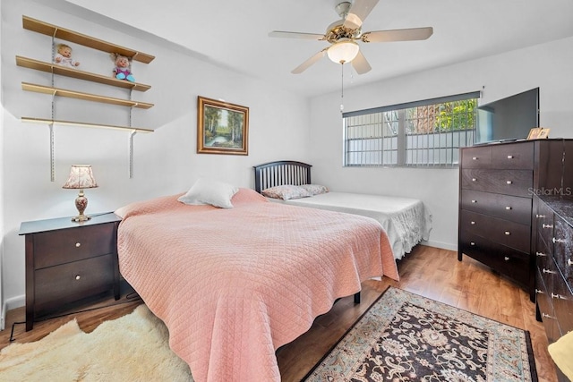 bedroom with light hardwood / wood-style flooring and ceiling fan