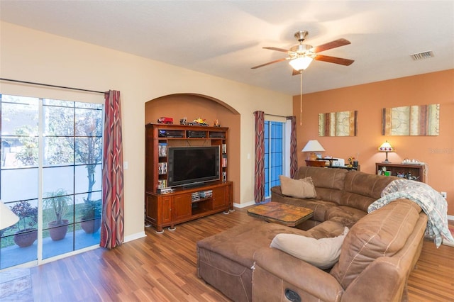 living room with hardwood / wood-style flooring and ceiling fan