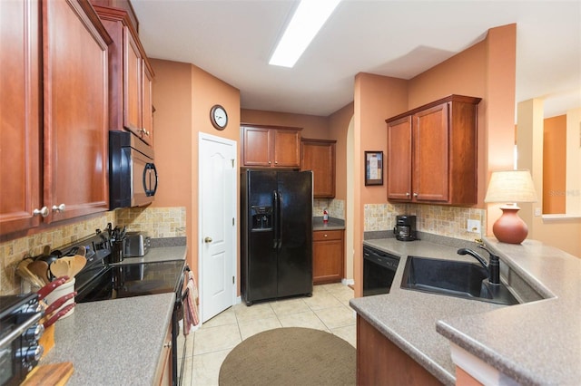 kitchen with black appliances, backsplash, light tile patterned flooring, and sink