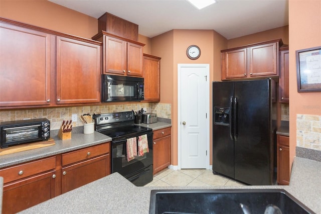 kitchen featuring black appliances, light tile patterned flooring, and tasteful backsplash