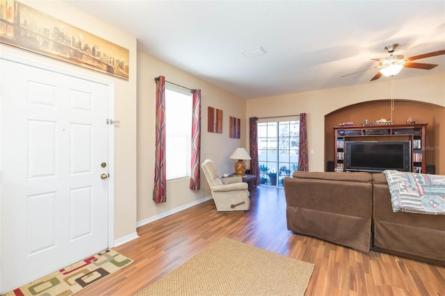 living room with light hardwood / wood-style floors and ceiling fan