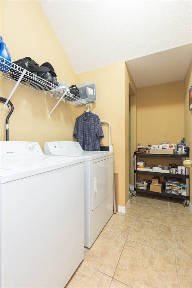 washroom with light tile patterned flooring and separate washer and dryer