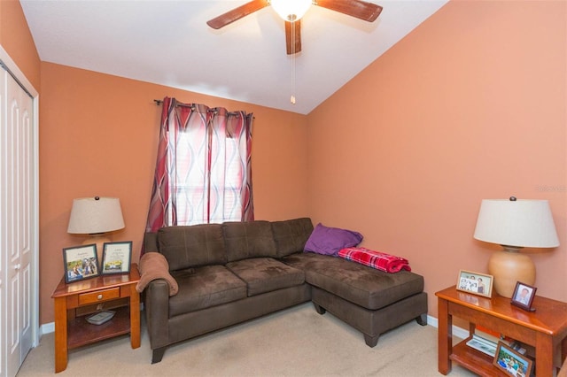 carpeted living room featuring ceiling fan and lofted ceiling