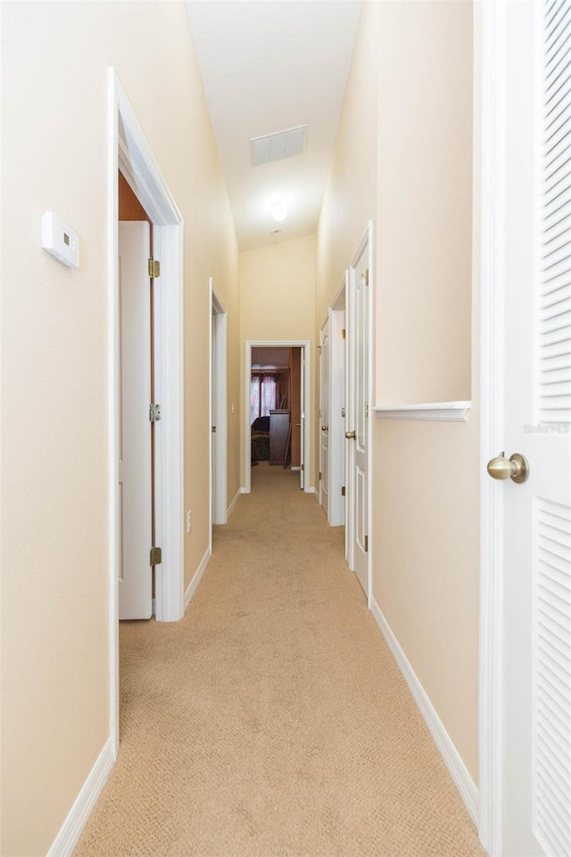 corridor with light colored carpet