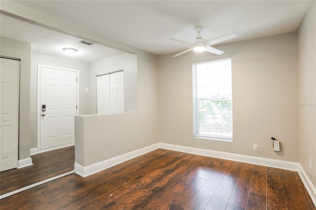 spare room with dark hardwood / wood-style floors and ceiling fan