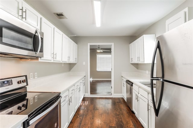 kitchen with white cabinets, stainless steel appliances, dark hardwood / wood-style floors, and ceiling fan