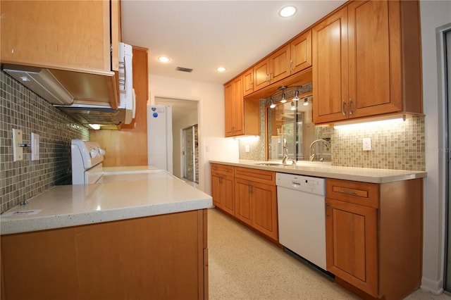 kitchen with light stone countertops, sink, backsplash, and white appliances