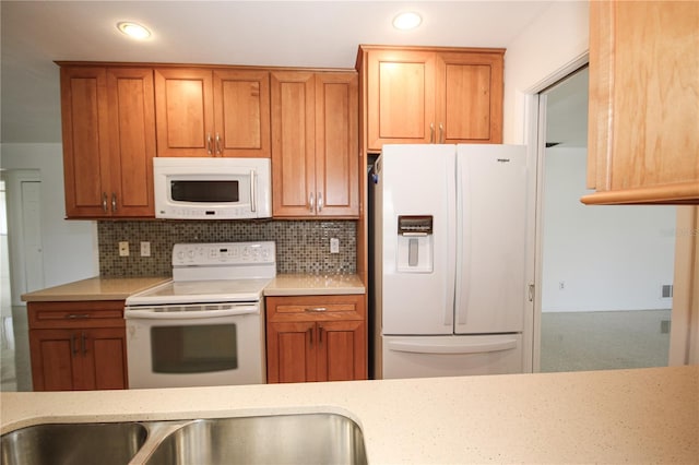 kitchen with white appliances, light stone countertops, and decorative backsplash