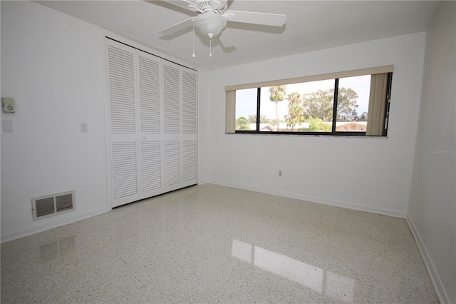 unfurnished bedroom featuring a closet and ceiling fan