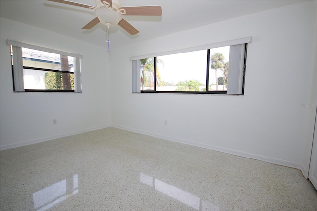 unfurnished room featuring plenty of natural light and ceiling fan