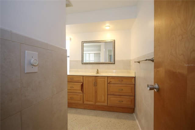 bathroom with tile walls and vanity