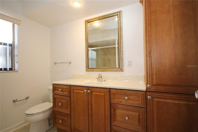 bathroom with vanity, toilet, and an enclosed shower