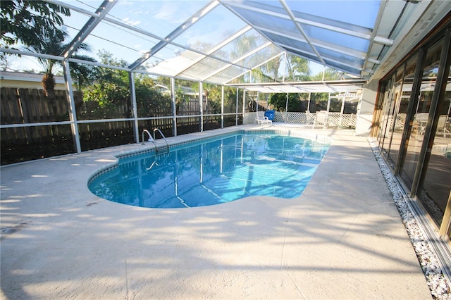 view of pool with a lanai and a patio area