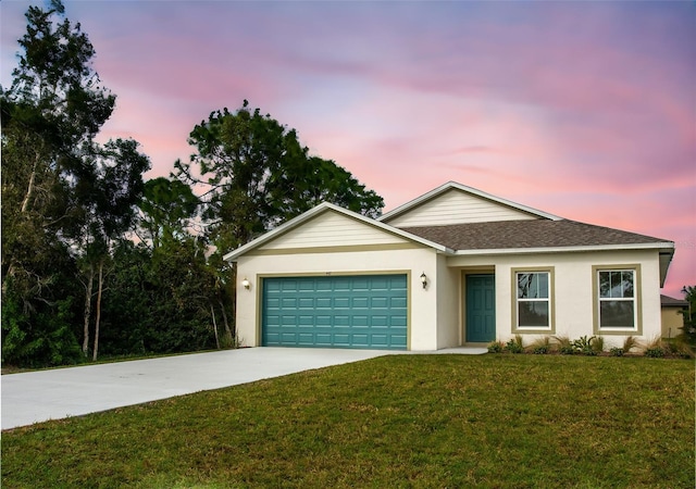 single story home featuring a garage and a yard