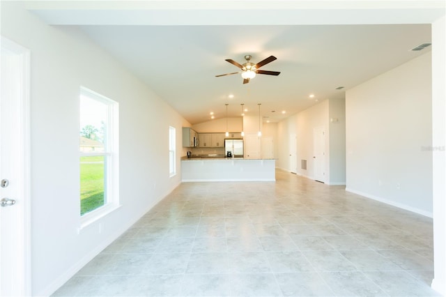 unfurnished living room with light tile patterned floors, vaulted ceiling, and ceiling fan