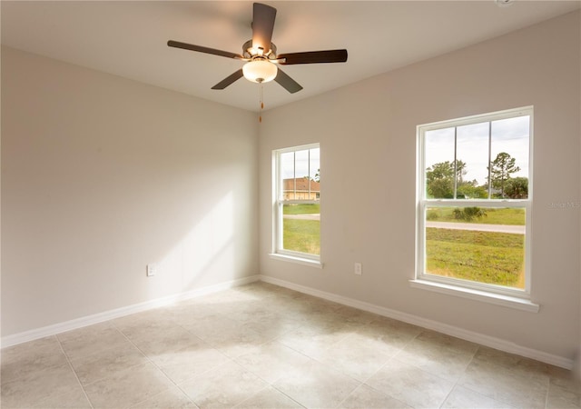 unfurnished room with light tile patterned floors and ceiling fan