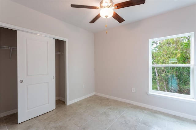 unfurnished bedroom featuring ceiling fan, a closet, and light tile patterned floors