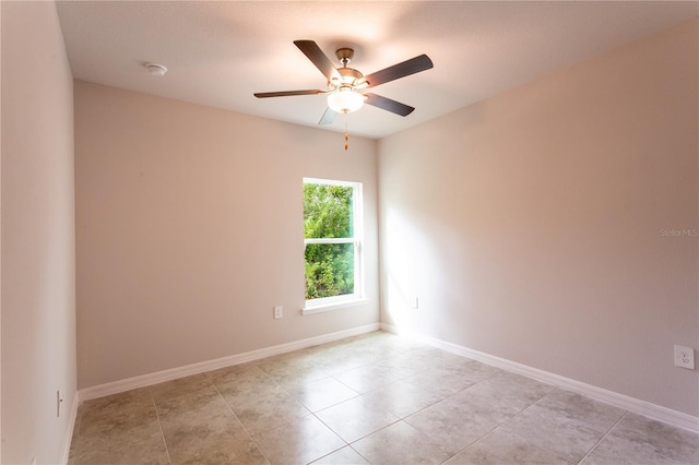 empty room featuring ceiling fan and light tile patterned flooring