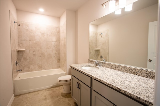 full bathroom featuring tiled shower / bath combo, toilet, and vanity