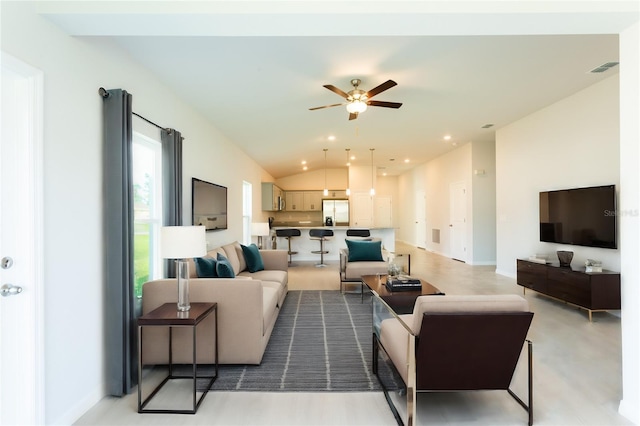 living room with ceiling fan and lofted ceiling