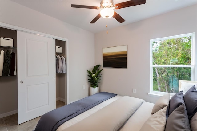 tiled bedroom with ceiling fan