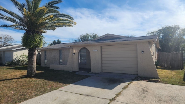 ranch-style house with a garage and a front yard