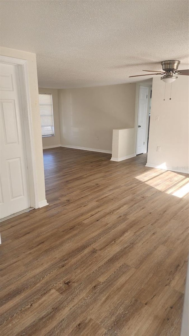 empty room featuring dark hardwood / wood-style flooring and a textured ceiling