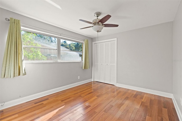 spare room with ceiling fan and light wood-type flooring