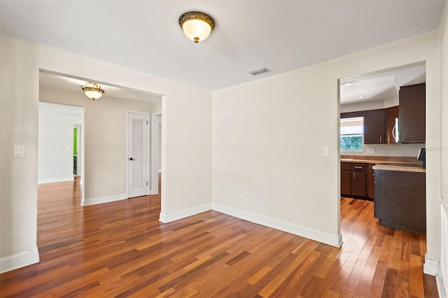 spare room with dark wood-type flooring