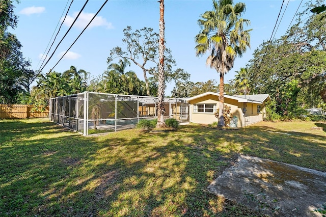 view of yard featuring glass enclosure