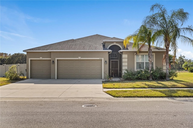 view of front of house featuring a front lawn and a garage