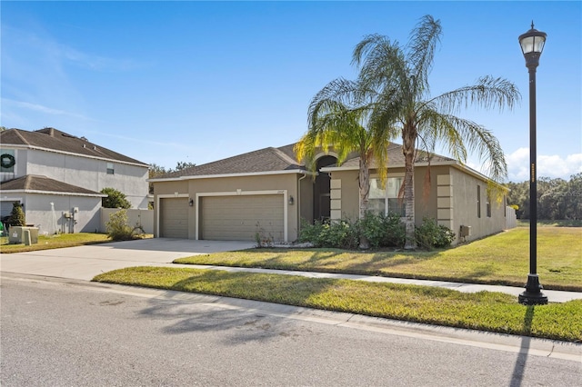 view of front of home with a front lawn and a garage