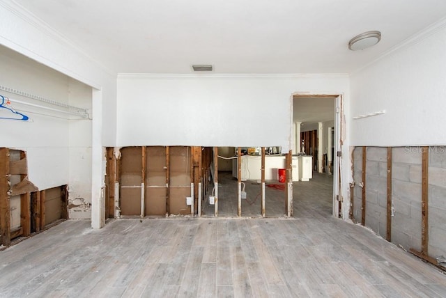 interior space featuring crown molding and wood-type flooring