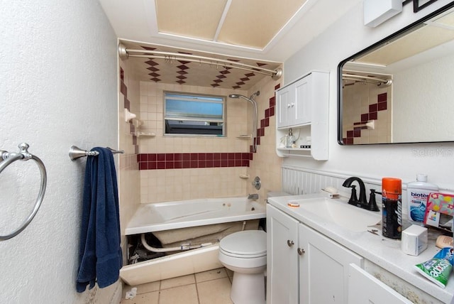 full bathroom with toilet, vanity, tiled shower / bath combo, and tile patterned flooring