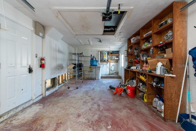 garage with a workshop area and a garage door opener