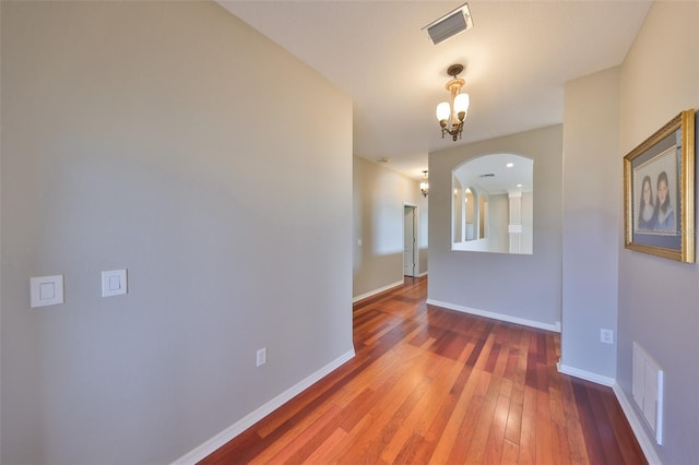 interior space with hardwood / wood-style flooring and a chandelier