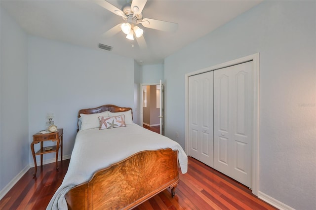 bedroom featuring a closet, dark hardwood / wood-style floors, and ceiling fan