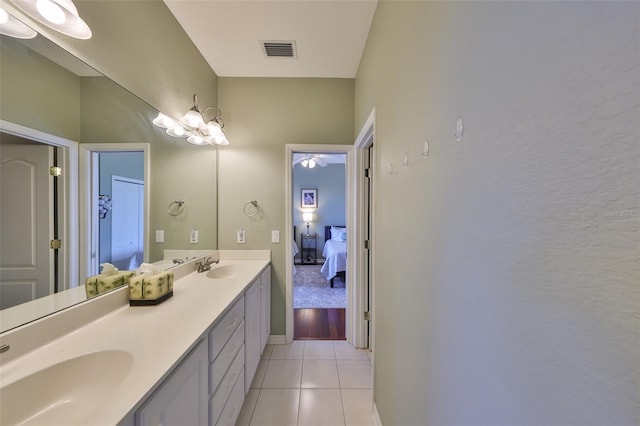 bathroom with vanity, tile patterned floors, and an inviting chandelier