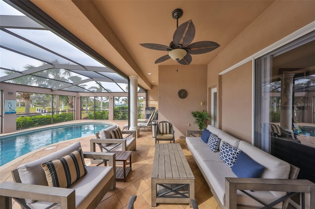 view of patio / terrace with an outdoor living space, ceiling fan, and glass enclosure