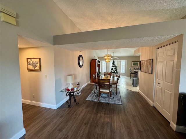 dining space with dark hardwood / wood-style floors and a textured ceiling