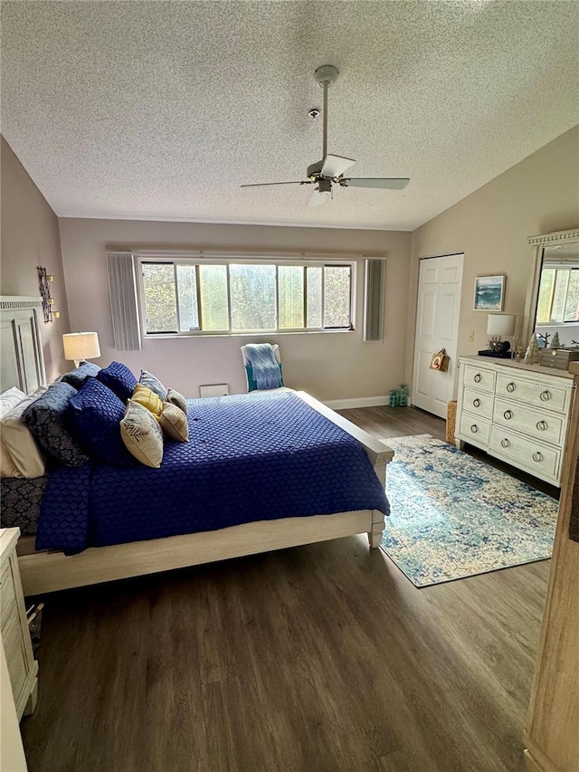 bedroom with lofted ceiling, dark hardwood / wood-style flooring, and multiple windows