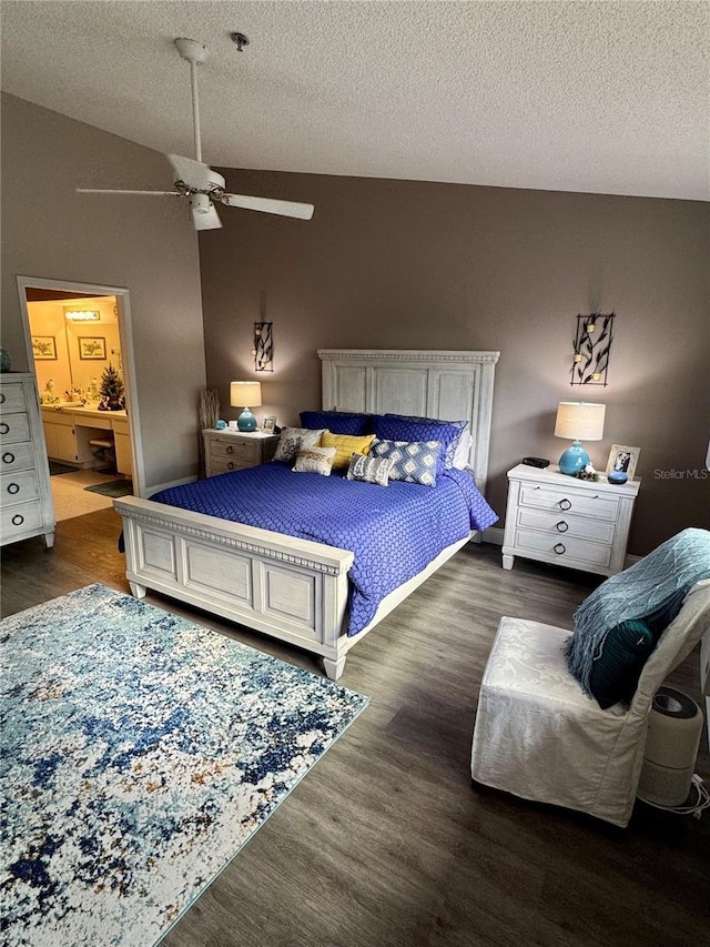 bedroom with dark wood-type flooring, lofted ceiling, connected bathroom, a textured ceiling, and ceiling fan