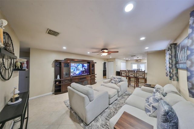 tiled living room with ceiling fan