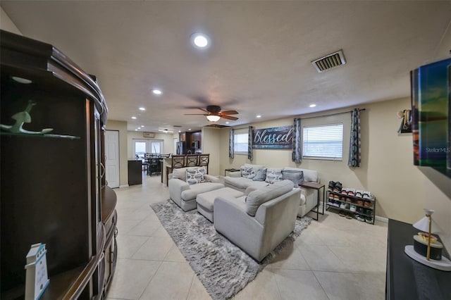 living room with ceiling fan and light tile patterned flooring