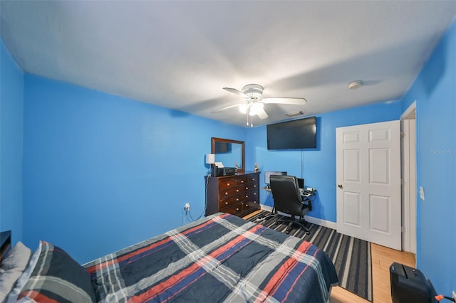 bedroom with hardwood / wood-style flooring and ceiling fan