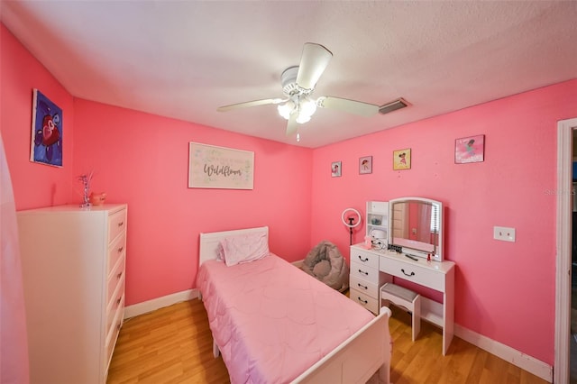 bedroom with ceiling fan and light wood-type flooring