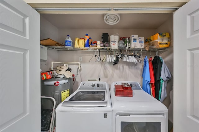 laundry room featuring washing machine and dryer and electric water heater